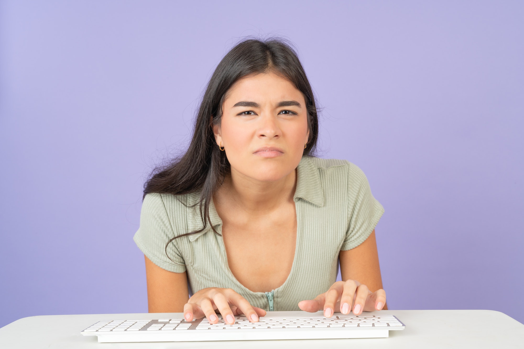 Serious and focused woman using computer